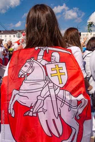 Vitebsk, Belarus - August 16, 2020 : a girl with national flag of the state of belarus , the rally in Belarus.