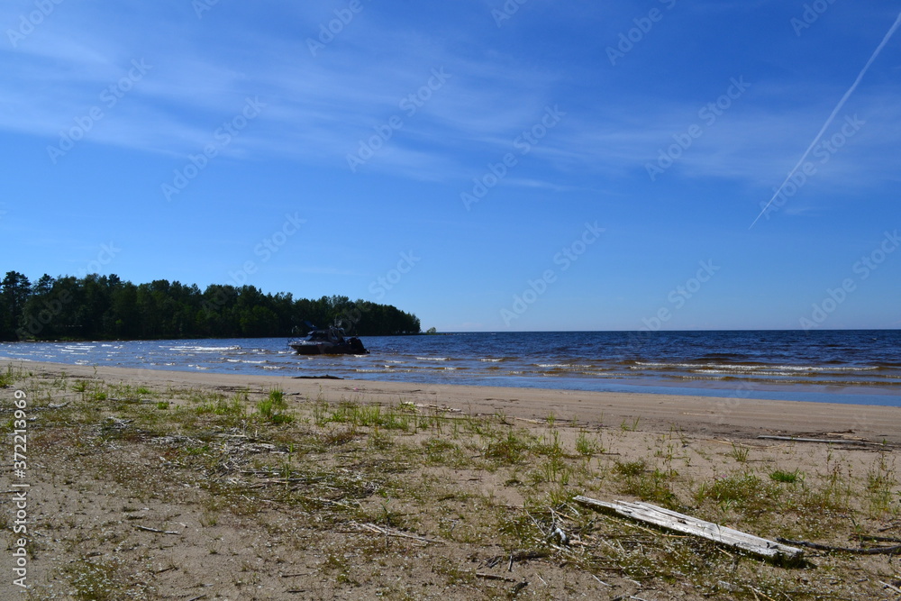 sandy shore of the Northern lake on a Sunny day