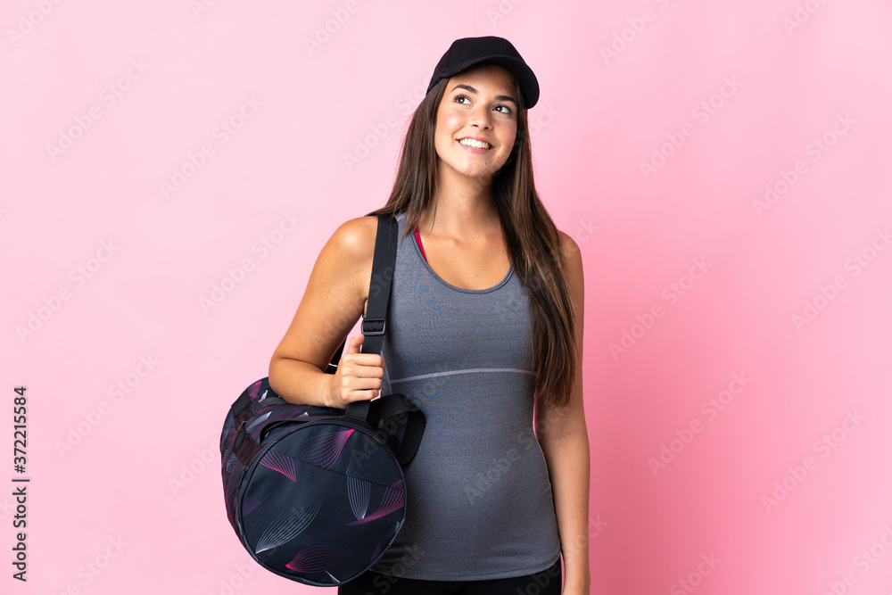Young sport brazilian girl with sport bag isolated on pink background thinking an idea while looking up Young sport brazilian girl with sport bag isolated on pink background thinking an idea while looking up