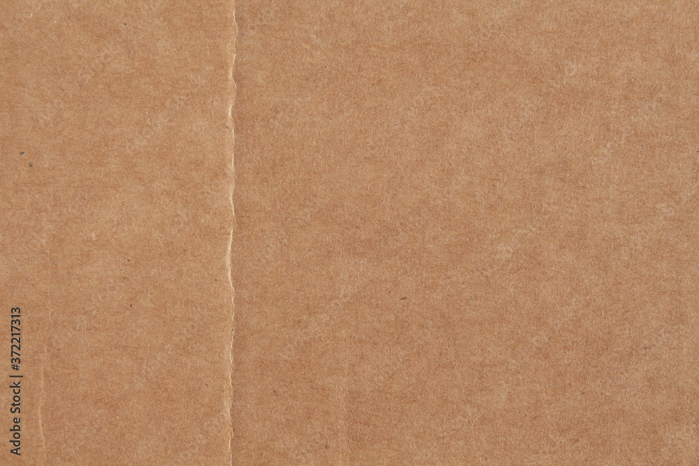 Texture of old crumpled cardboard with a fold Texture of old crumpled cardboard with a fold