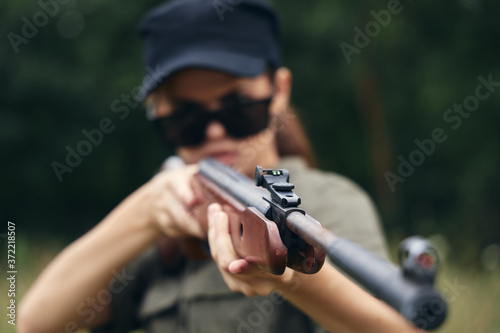 Woman muzzle of a gun sight is a hunting target fresh air