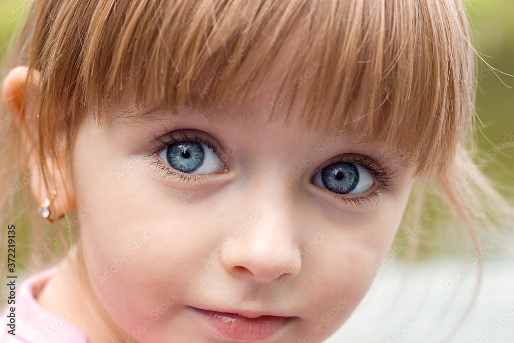 Portrait of beautiful cute little girl face close-up, look of innocence blue eyes Portrait of beautiful cute little girl face close-up, look of innocence blue eyes