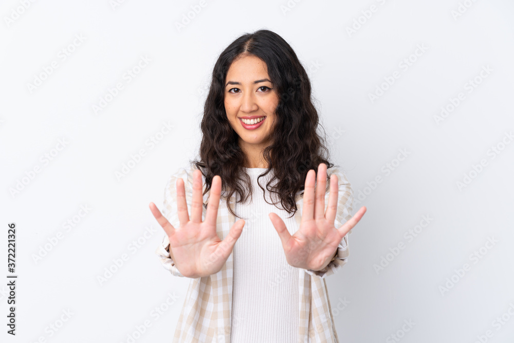 Mixed race woman over isolated white background counting ten with fingers Mixed race woman over isolated white background counting ten with fingers