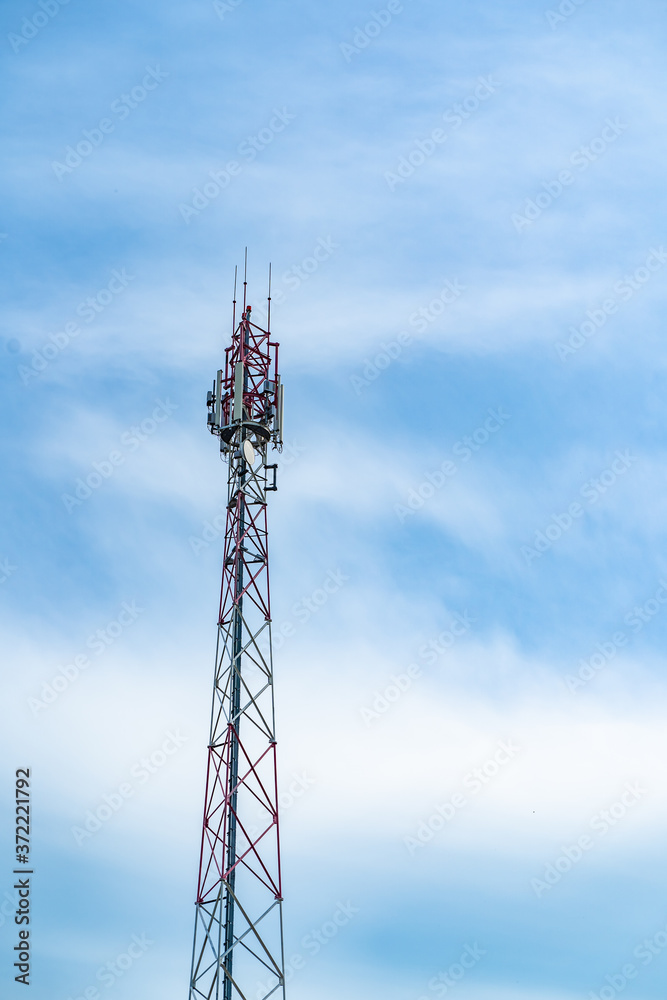 Telecommunication tower of 4G and 5G cellular. Macro Base Station. Wireless Communication Antenna Transmitter. Telecommunication steel high tower with antennas against blue sky. Telecommunication tower of 4G and 5G cellular. Macro Base Station. Wireless Communication Antenna Transmitter. Telecommunication steel high tower with antennas against blue sky.