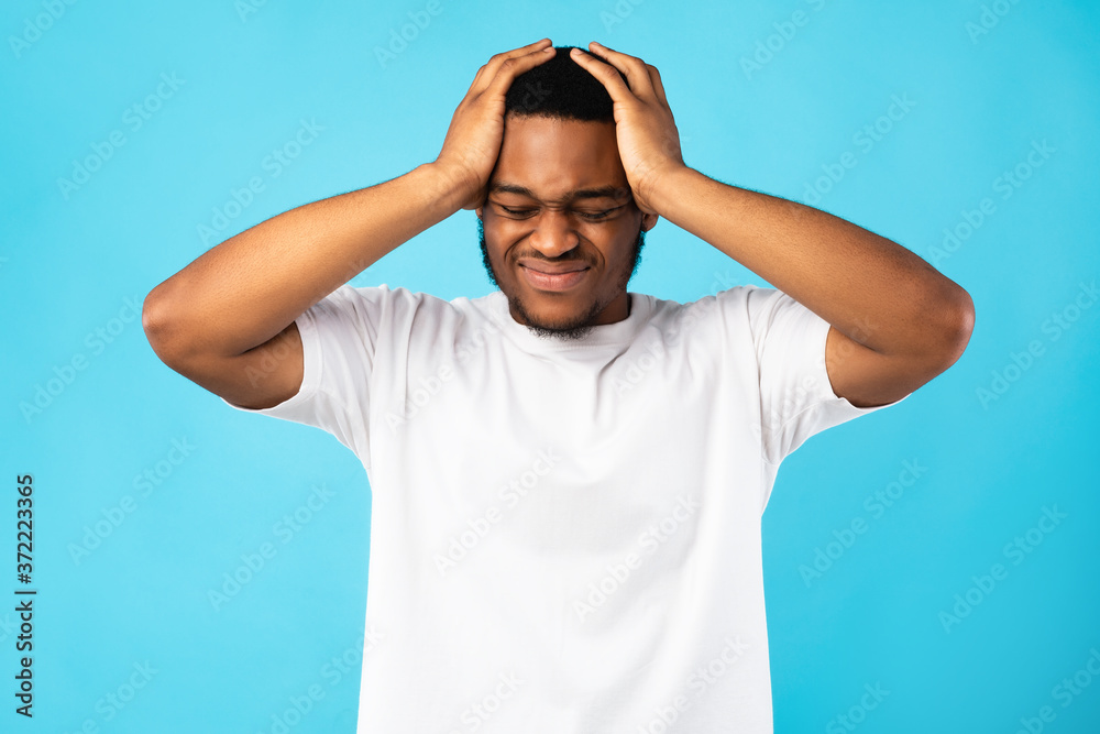 Black Man Suffering From Headache Touching Head, Blue Background Black Man Suffering From Headache Touching Head, Blue Background