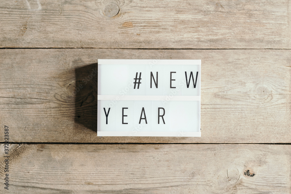 New Year text in led panel with wooden background New Year text in led panel with wooden background