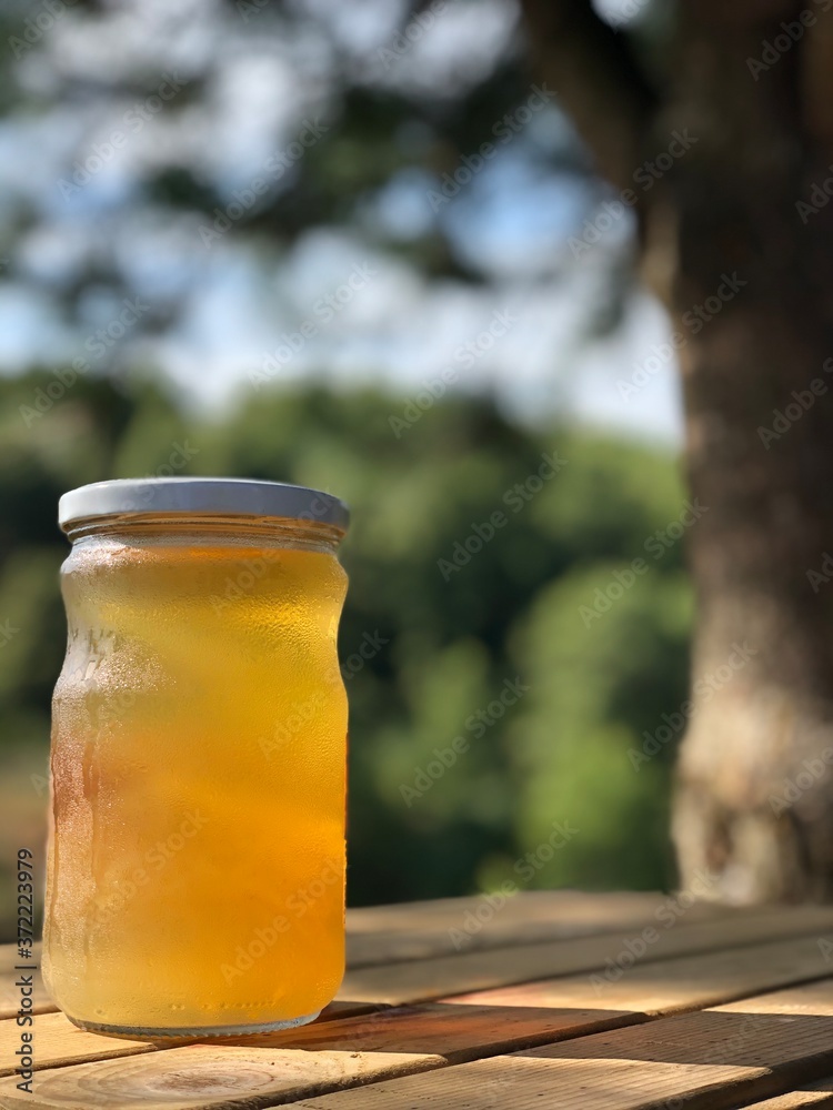 apple cider vinegar in jar on wooden table apple cider vinegar in jar on wooden table