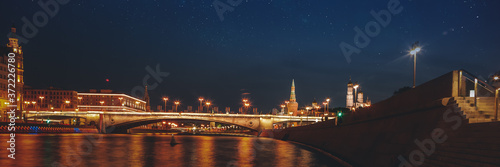 Moscow, the capital of Russia. Night landscape, view of the city center and the river at night. Starry sky over the city.