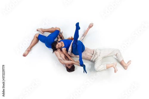 Deep. Group of modern dancers, art contemp dance, blue and white combination of emotions. Flexibility and grace in motion and action on white studio background. Fashion and beauty, artwork concept.
