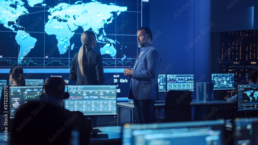 Project Manager And Computer Science Engineer Talking While Using Big project-manager-and-computer-science-engineer-talking-while-using-big