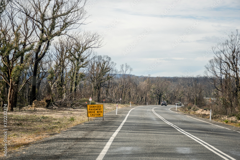 Damaged pavement sign on Nerriga road. Australian bushfires aftermath ...