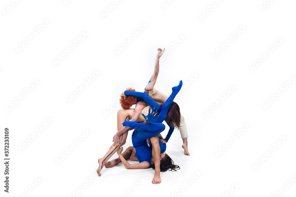 Flexible. Group of modern dancers, art contemp dance, blue and white combination of emotions. Flexibility and grace in motion and action on white studio background. Fashion and beauty, artwork concept