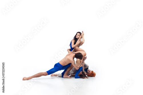 Line. Group of modern dancers, art contemp dance, blue and white combination of emotions. Flexibility and grace in motion and action on white studio background. Fashion and beauty, artwork concept.