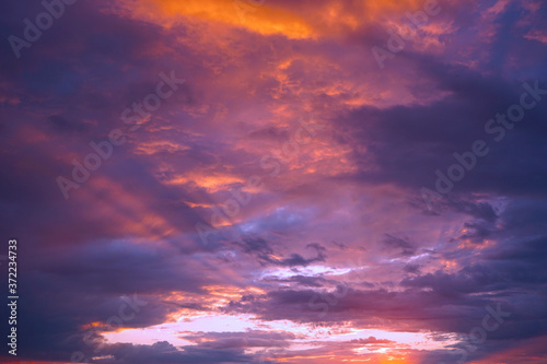 Sunset in the clouds. Blue orange purple sunset background. A bright beautiful sunset on a dramatic sky. Cloudscape. Evening thunderstorm. © Наталья Босяк