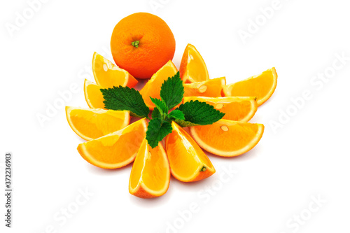 Orange with slices and green leaf of mint isolated on white background