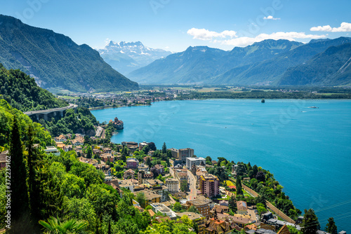 Fototapeta Naklejka Na Ścianę i Meble -  Aerial view of Geneva lake with Swiss Alps panorama from Montreux to Villeneuve and Chillon castle in Veytaux city Switzerland