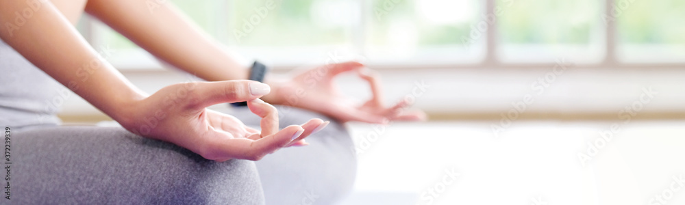 Close up of woman hand practice yoga meditation exercise at home with copy space, Yoga posture banner - obrazy, fototapety, plakaty 