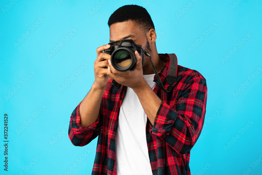 African American Photographer Taking Photo Standing On Blue Background African American Photographer Taking Photo Standing On Blue Background