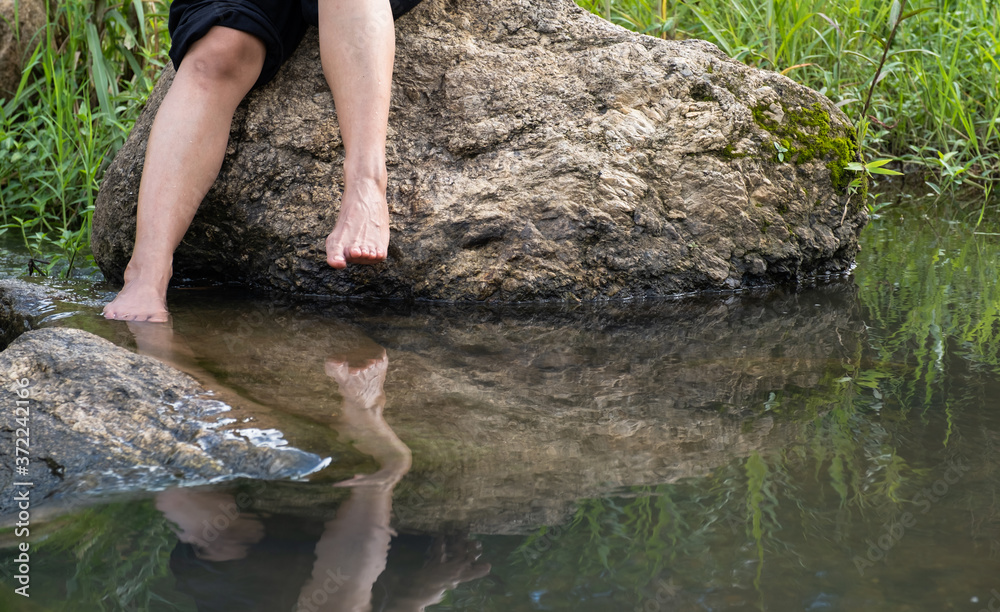 feet Soak with water streams relaxing in nature or nature spa concept feet Soak with water streams relaxing in nature or nature spa concept