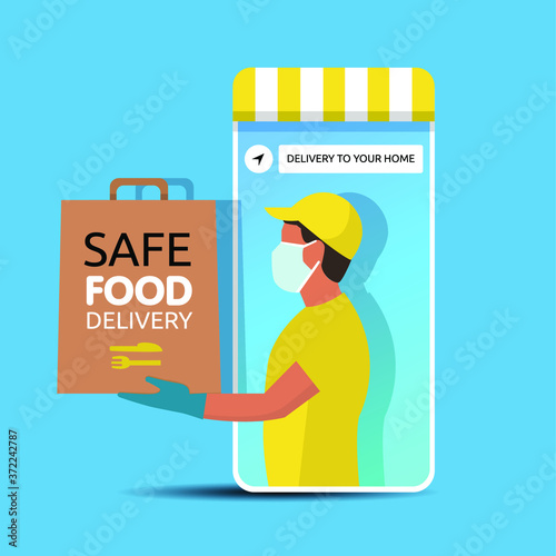 Delivery man holding a bag with fast food out of the phone. Fast food delivery app on a smartphone with delivery man, wearing a face mask and gloves. Safe food delivery during coronavirus epidemic