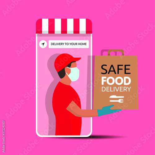 Delivery man holding a bag with fast food out of the phone. Fast food delivery app on a smartphone with delivery man, wearing a face mask and gloves. Safe food delivery during coronavirus epidemic