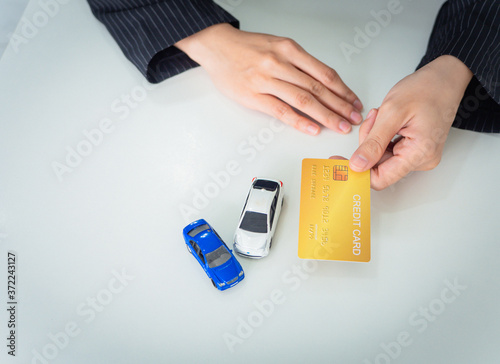 Topview, business woman is holding credit card in hand to buy new car or invest in car, business financial concept. copy-space in white background