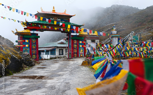 Colorful gateway with Buddhist prayer flags in Himalayas. Tawang, India.