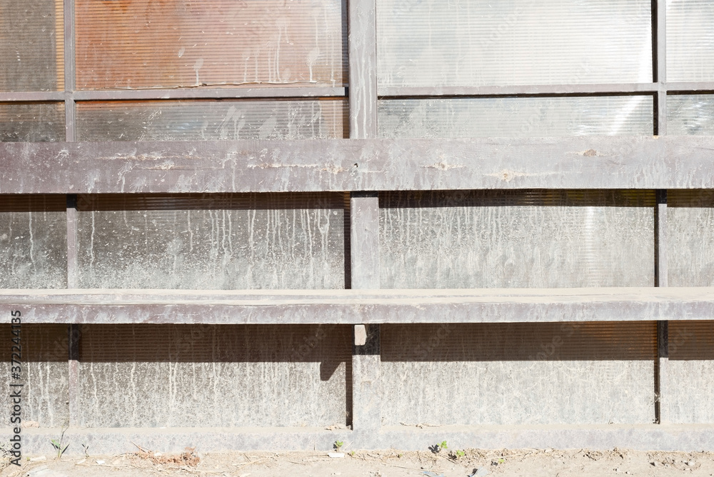 a dirty bus stop smeared with whitewash stains. Deserted station, wooden stop, bench a dirty bus stop smeared with whitewash stains. Deserted station, wooden stop, bench