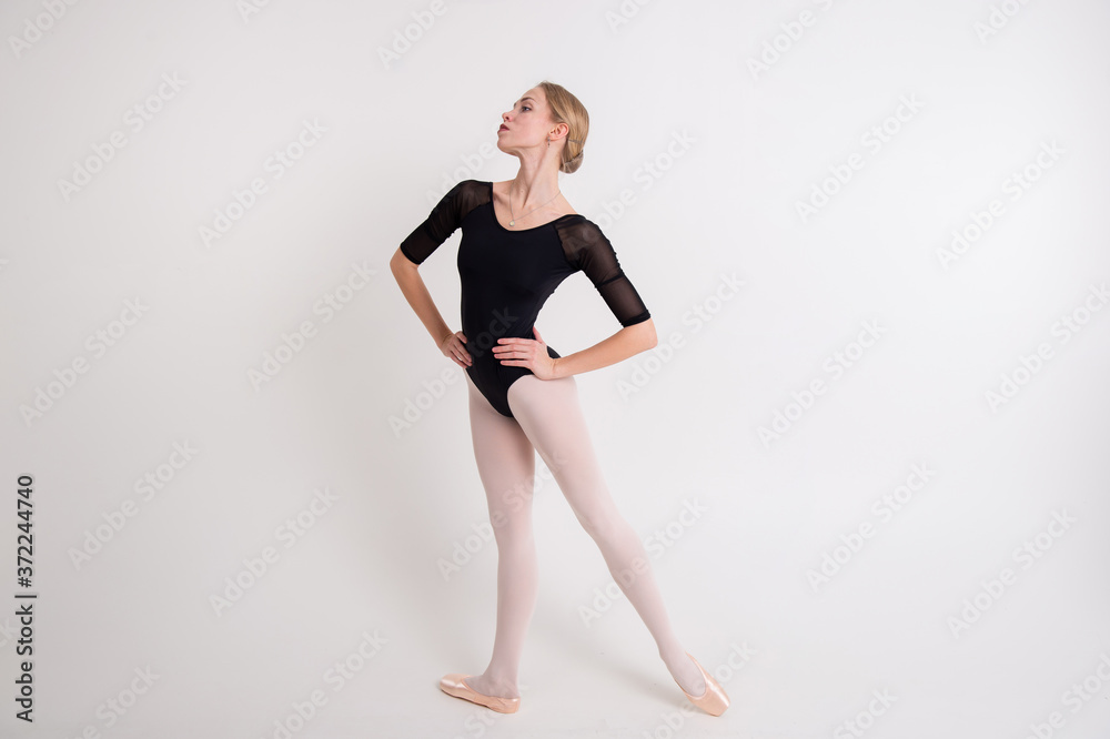 The portrait of beautiful young blonde woman gymnast training calilisthenics exercise on white studio background. The portrait of beautiful young blonde woman gymnast training calilisthenics exercise on white studio background.