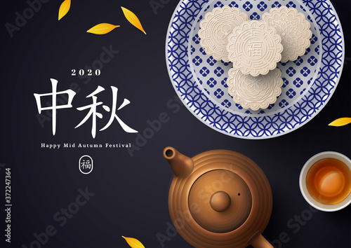 White snow mooncakes on porcelain plate, teapot and teacup. Chinese translation is blessing and Mid Autumn. Flat lay of tea ceremony with cookies, pot and yellow petals. China holiday poster design.