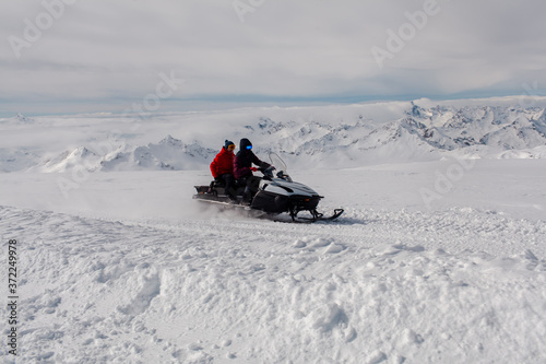  snowmobile on the background of mountain peaks