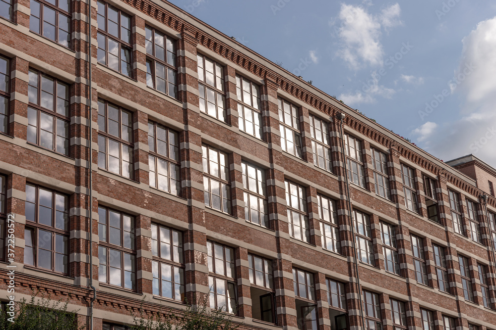 Fototapeta premium Restored red brick building. Modern office building