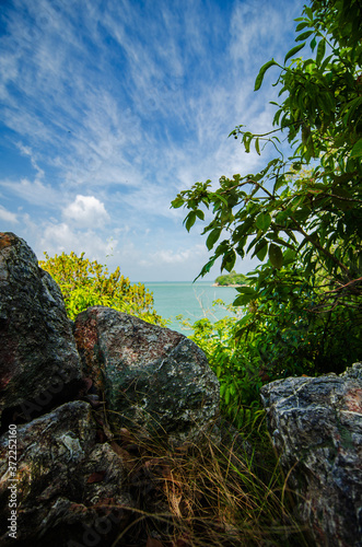 beauty in nature, tropical seashore view from hill top, under bright sunny day and cloudy sky