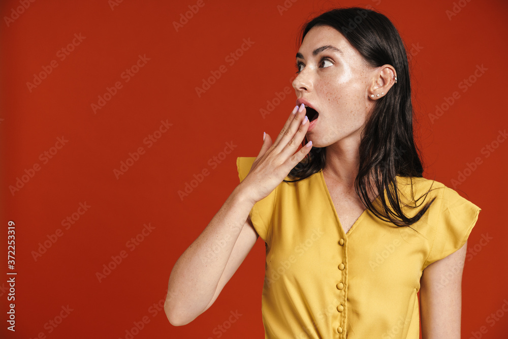 Image of young shocked woman expressing surprise and covering her mouth Image of young shocked woman expressing surprise and covering her mouth