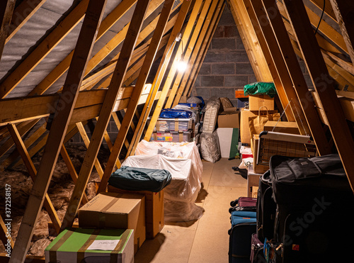 Loftspace in the attic roof of a family home, is a favourite storage place for cases, boxes and personal treasures. photo