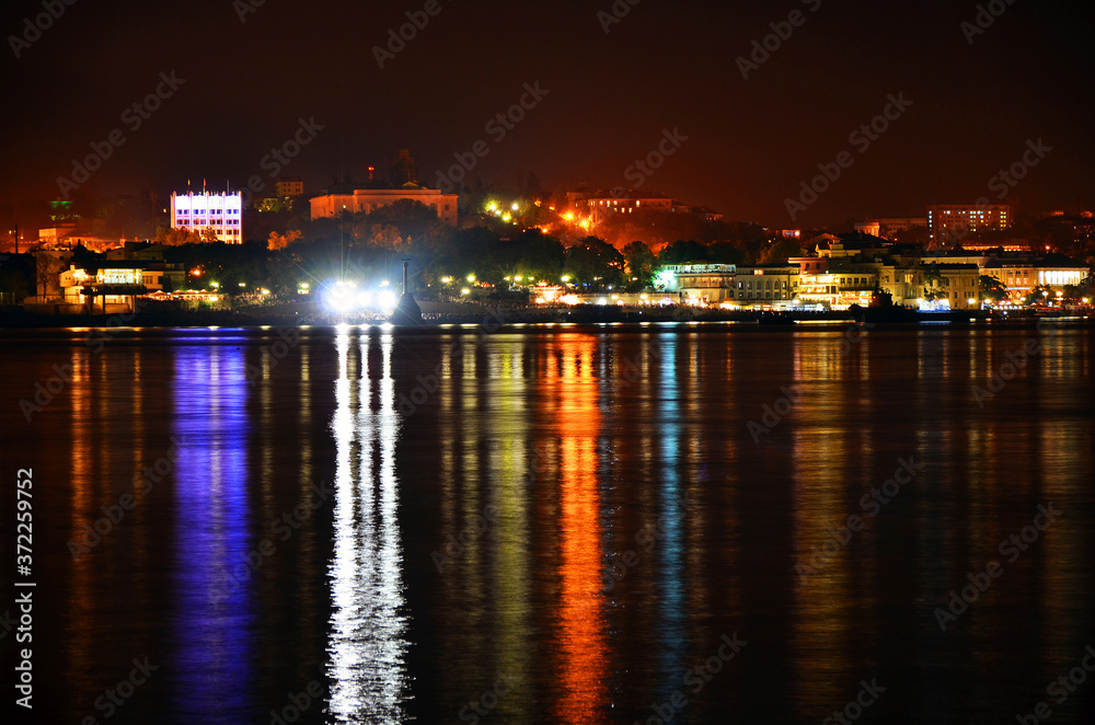 Lights of the night Sevastopol and their reflection in the sea