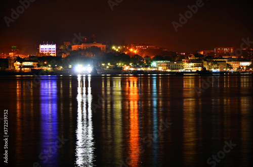 Lights of the night Sevastopol and their reflection in the sea © Sergey