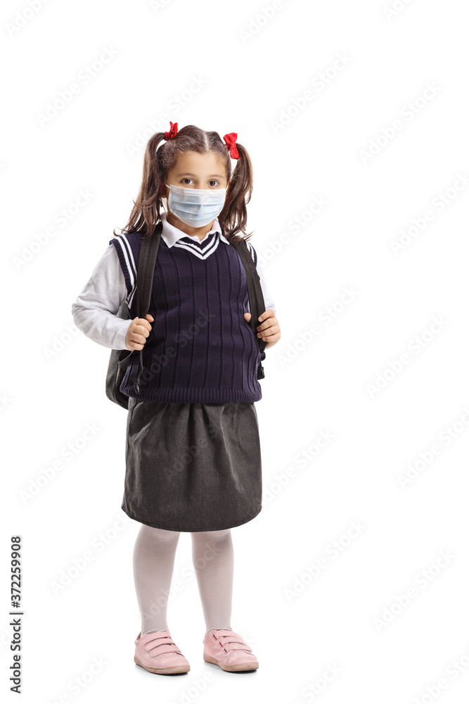 Full length portrait of a schoolgirl with a backpack wearing a protective face mask Full length portrait of a schoolgirl with a backpack wearing a protective face mask