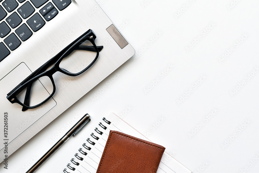 Top view office desk, White table space for ideas with laptop, glasses, wallet, book and pen is elements. Top view office desk, White table space for ideas with laptop, glasses, wallet, book and pen is elements.