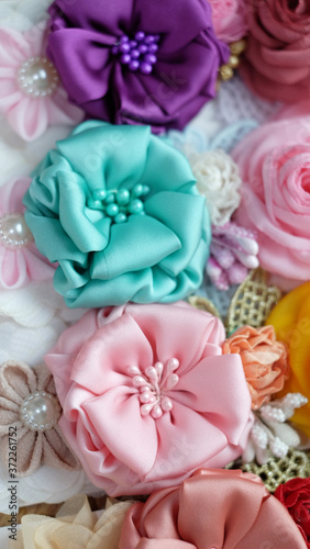 A bouquet of flowers made out of fabric cloth textile in beautiful pastel colors that can be used as hair accessory  decoration  and embellishment