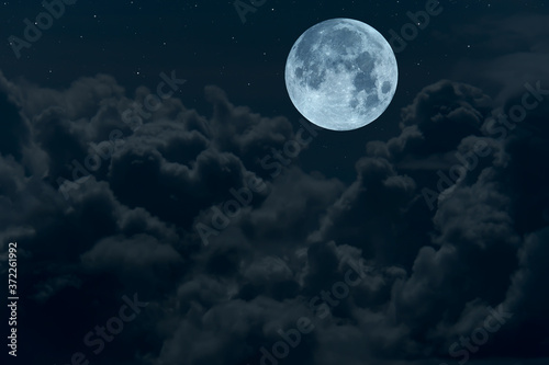 Full moon with blurred dark clouds in the night. © Onkamon