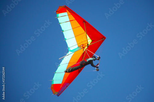 CRIMEA, UKRAINE - SEPTEMBER 4: Competitor Victor Parhomenko of the Grininko hang gliding competitions takes part in the Klementieva mountain on September 4, 2012 in Crimea, Ukraine photo