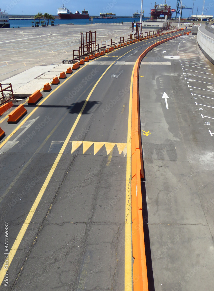 Aerial view of empty road and infrastructure under construction in the loading and unloading port. Maritime and industrial transport background. Aerial view of empty road and infrastructure under construction in the loading and unloading port. Maritime and industrial transport background.