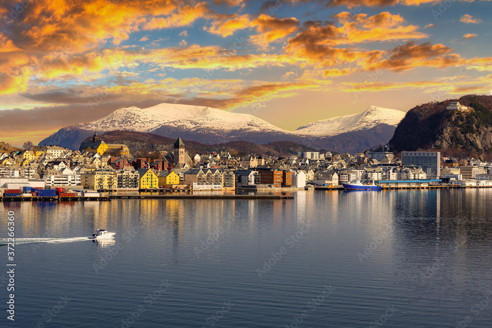 Architecture of Alesund town reflected in the water at sunset, Norway