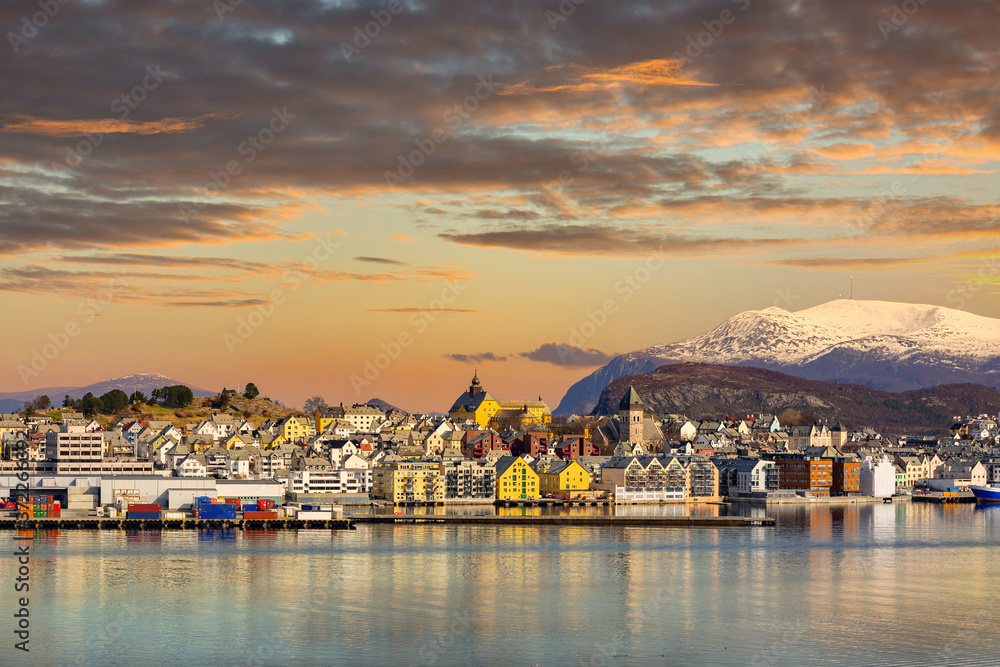 Architecture of Alesund town reflected in the water at sunset, Norway