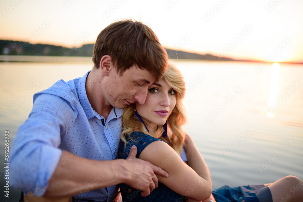 Man and woman on the pier near the lake.