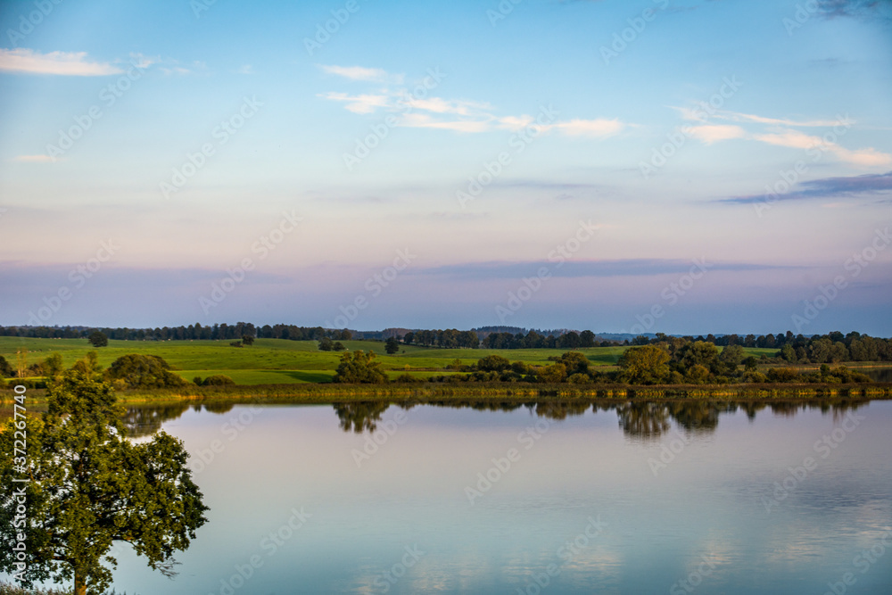 Obraz premium Panoramic view at sunset on a beautiful lake in Masuria region (Mazury), Poland