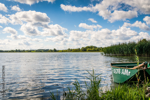 Panoramic view of on a beautiful lake with a small boat in Masuria region (Mazury), Poland