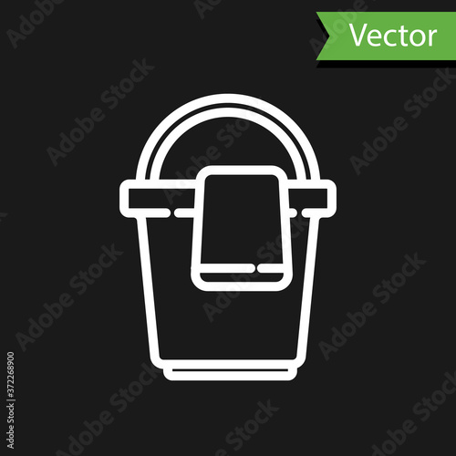White line Bucket with rag icon isolated on black background. Cleaning service concept. Vector Illustration.