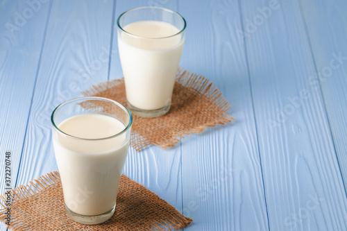 Glass of milk on table close up photo